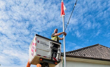 Drei Monteure der Heidjers Stadtwerke schmücken das Heideblütenfest mit energiesparenden LED-Lichterketten.